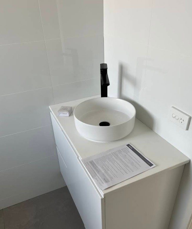 Modern round basin with matte black tap