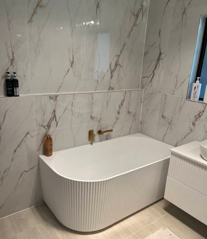 Modern fluted bathtub with brass tap